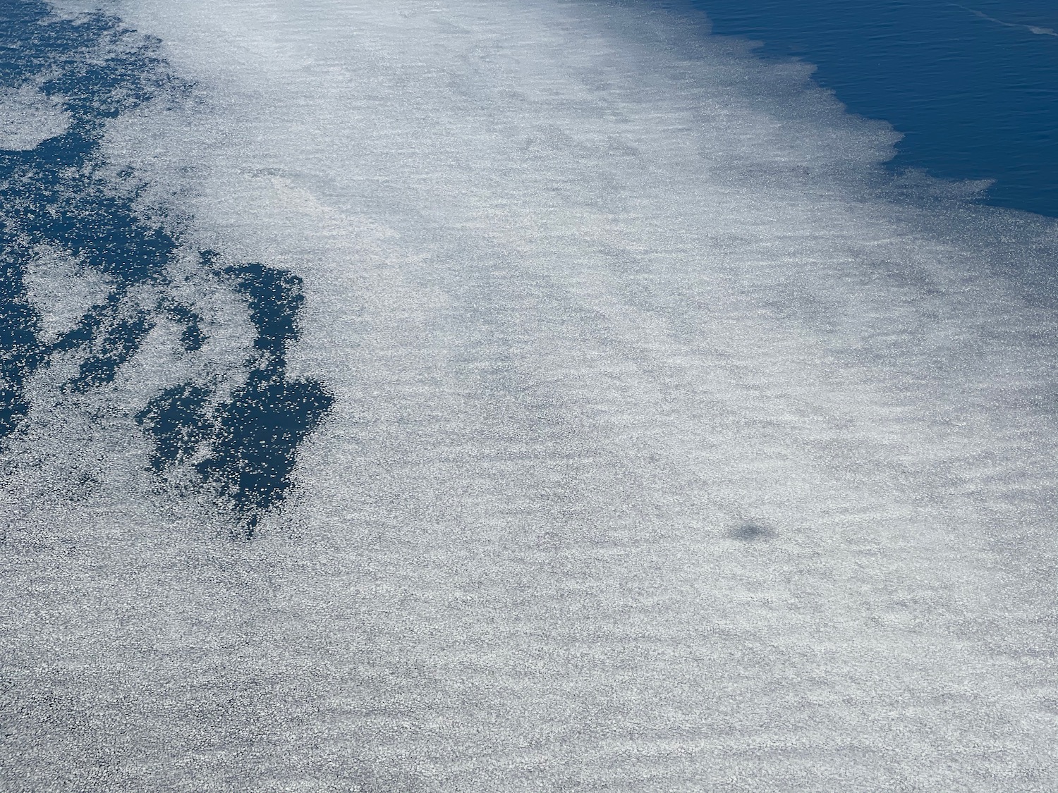 a white foamy surface in the ocean