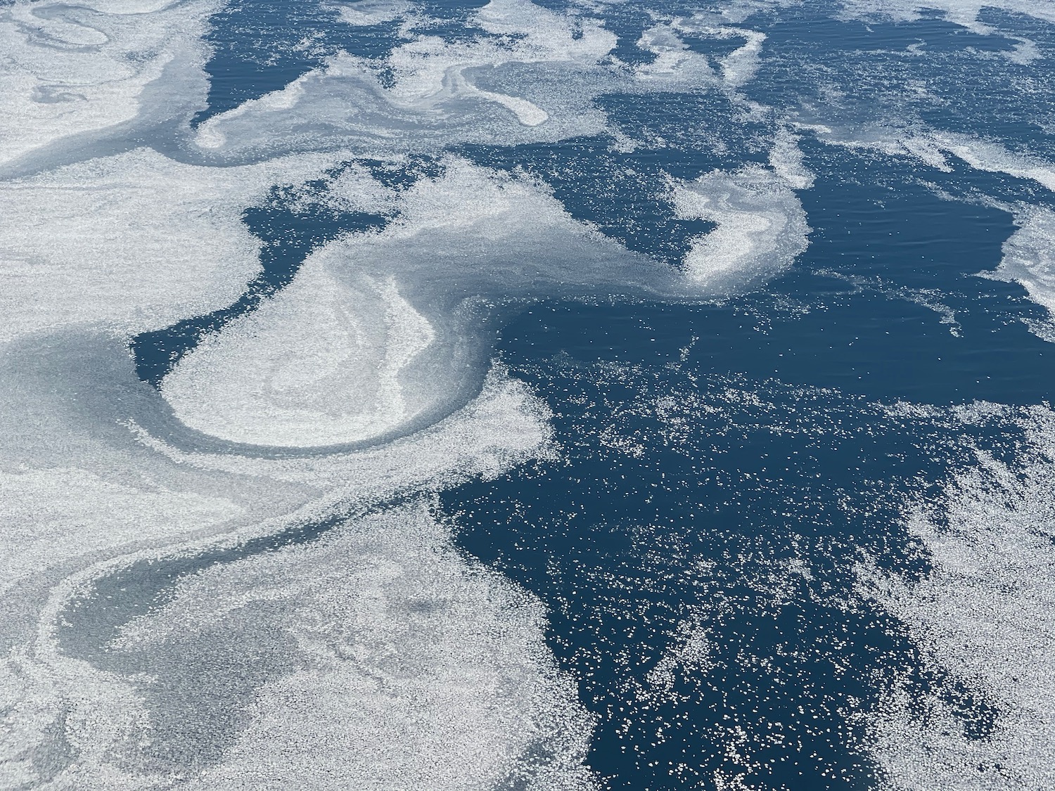 a body of water with white foam