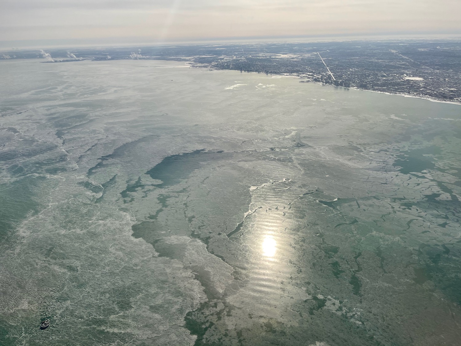 an aerial view of a body of water with a city in the background