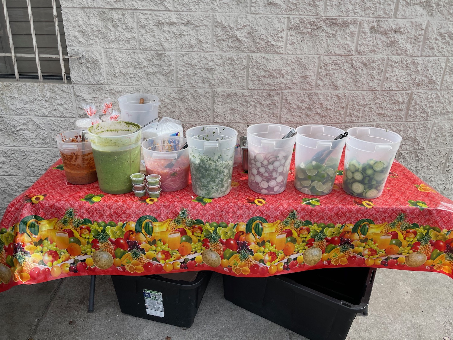 a table with plastic containers of food on it