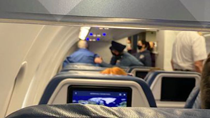 a group of people sitting on an airplane