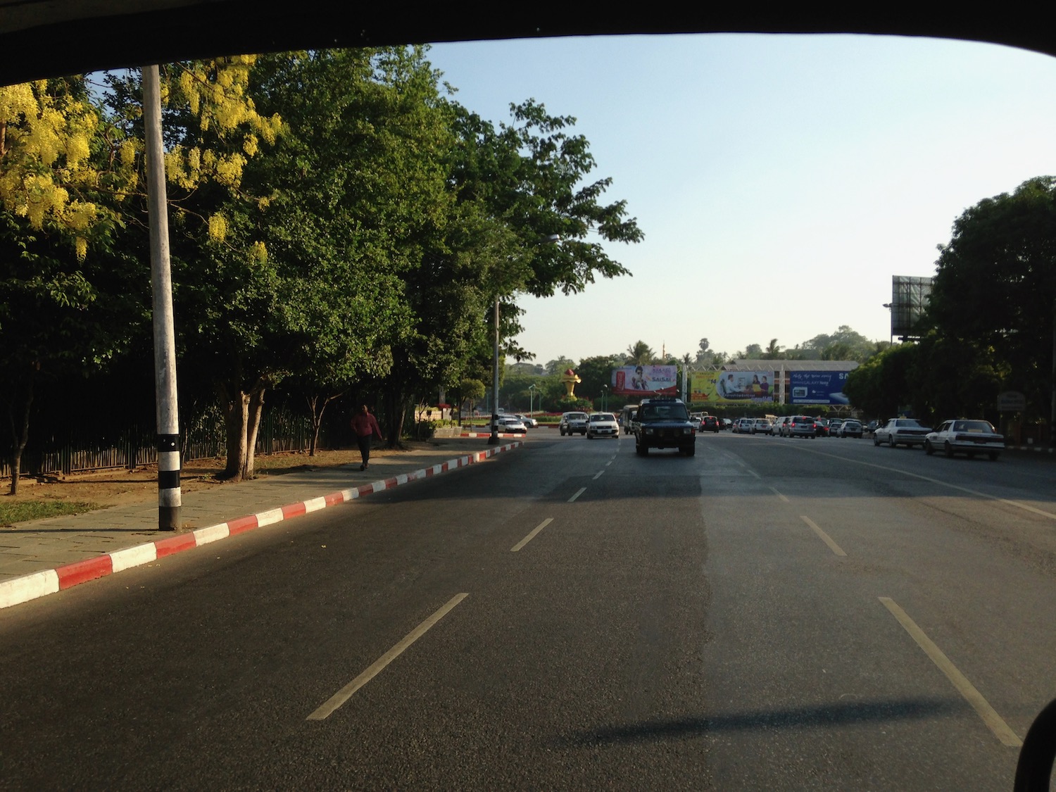 a road with cars and trees