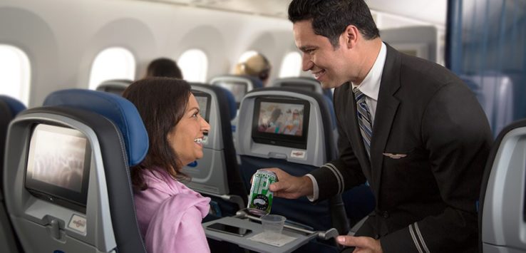 a man serving a drink to a woman