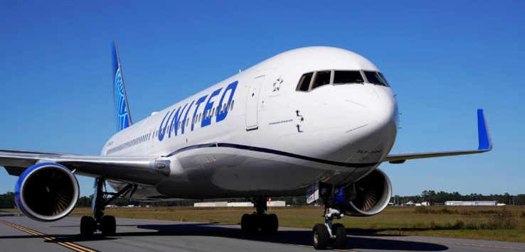 a white airplane on a runway