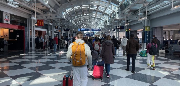 a group of people walking in a terminal