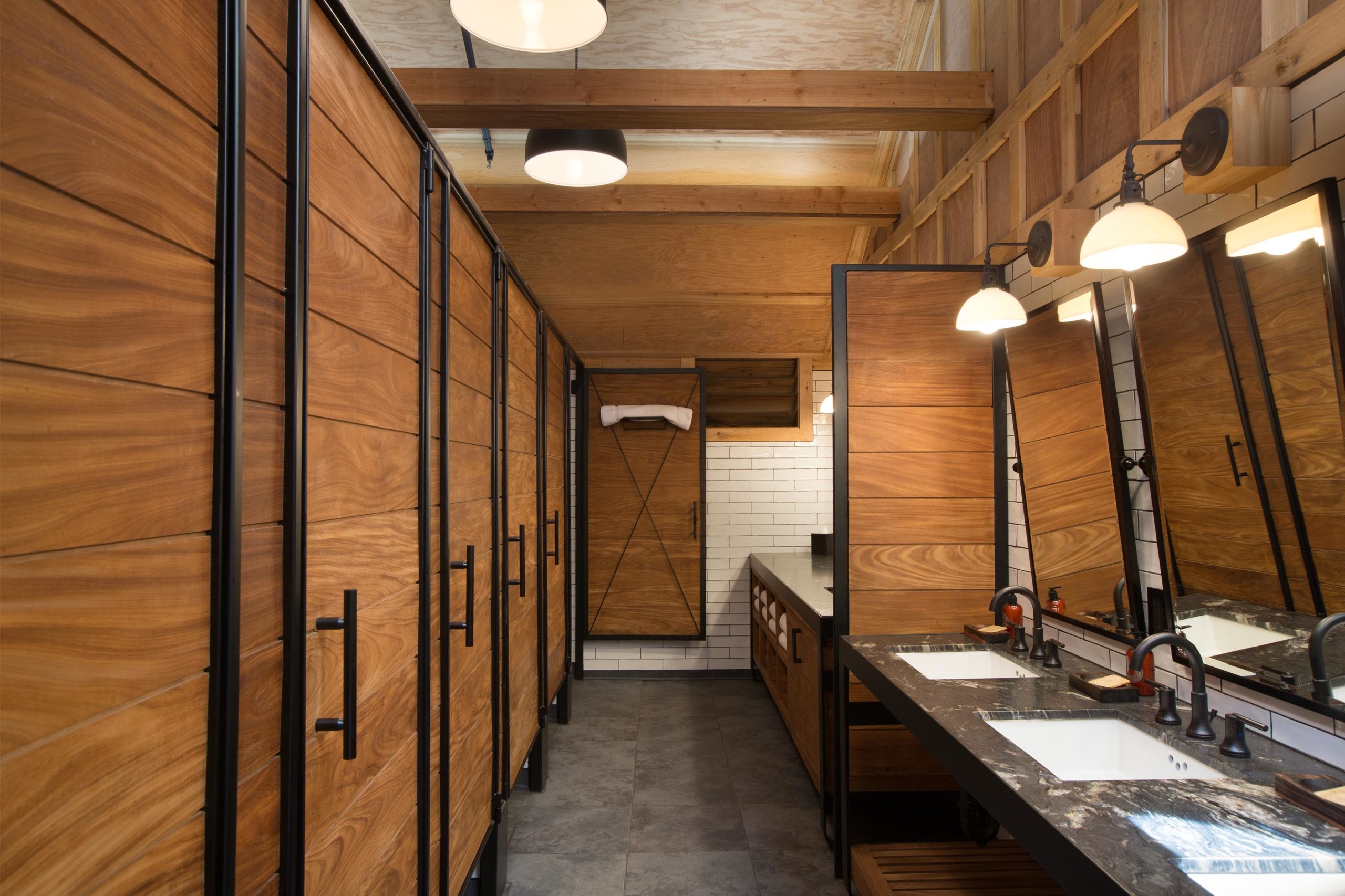 a bathroom with wood cabinets and sinks