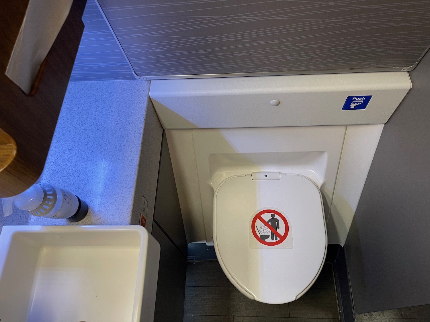 a toilet with a sticker on the lid