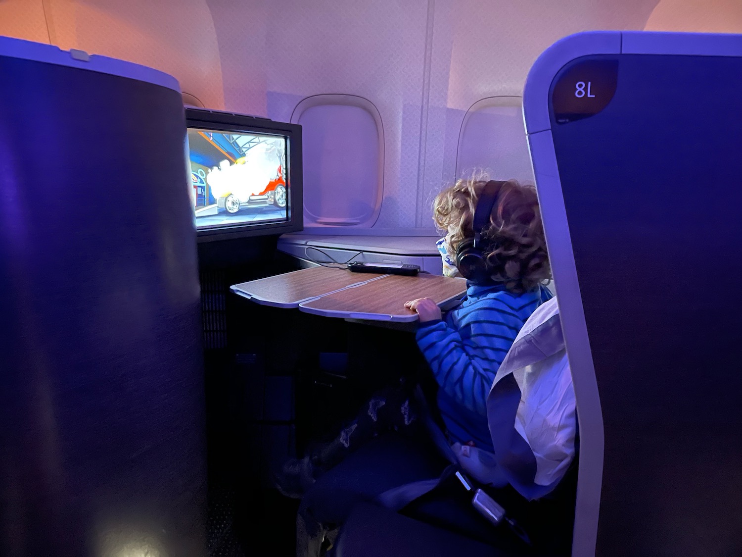 a child sitting in a chair in an airplane