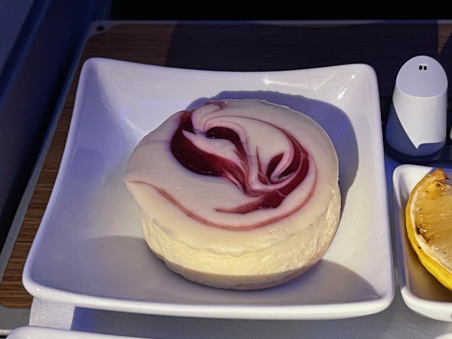 a white and red dessert on a square white plate