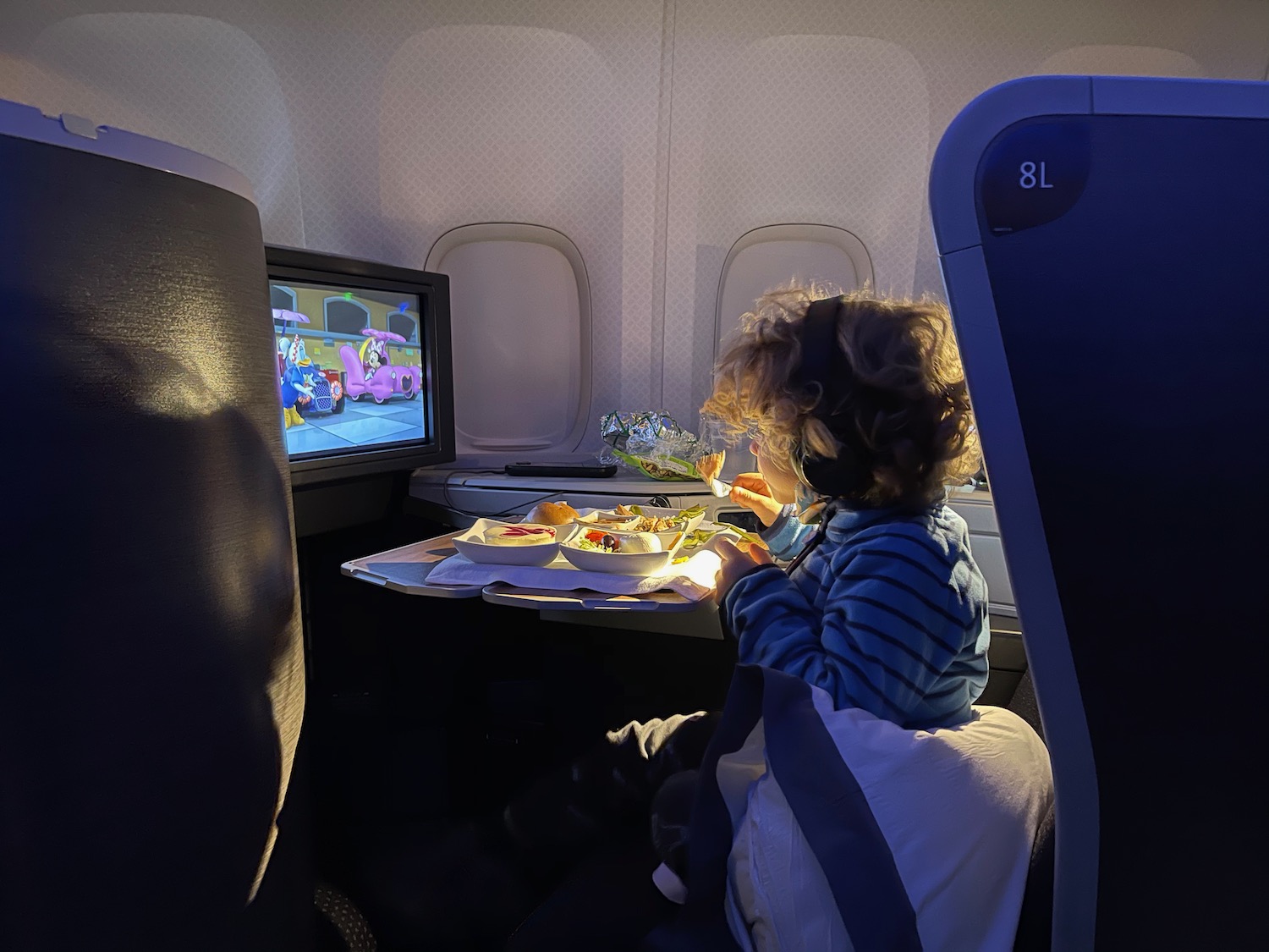 a child eating food in an airplane