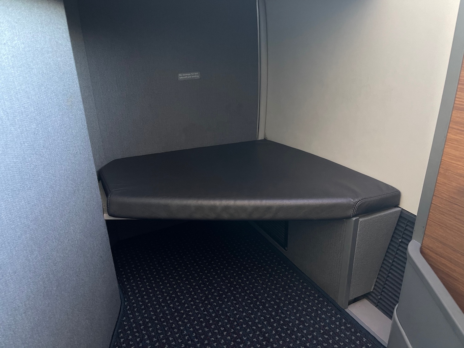 a black cushioned seat in a small room