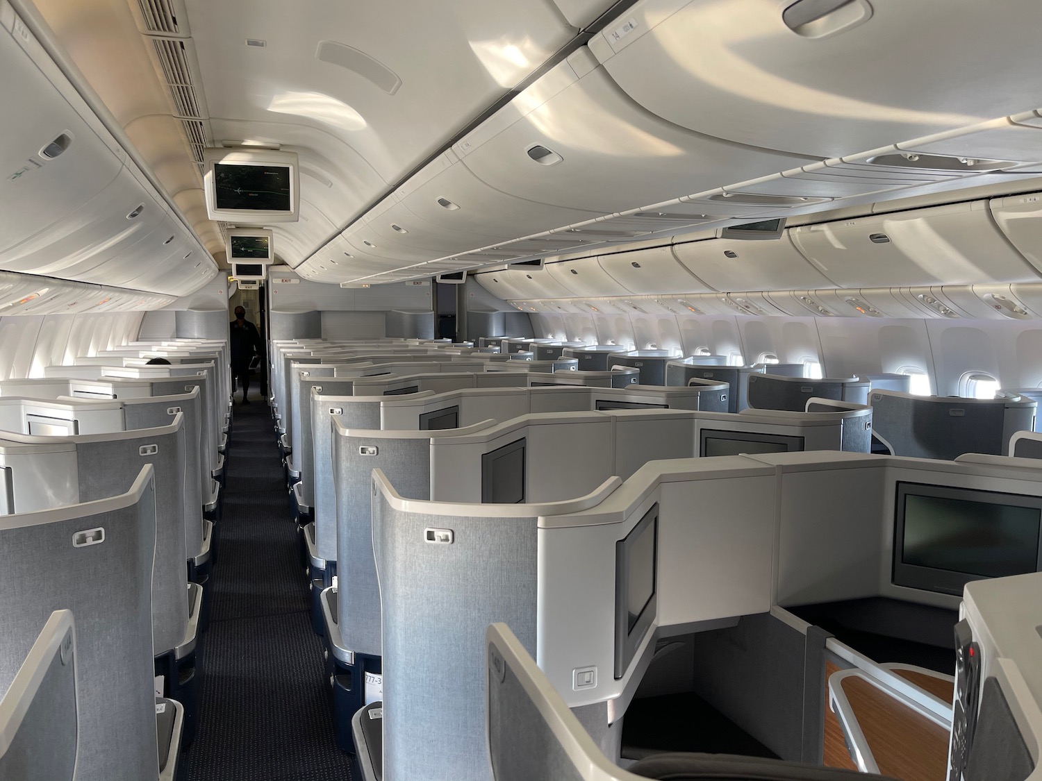 an airplane with seats and a person standing in the back