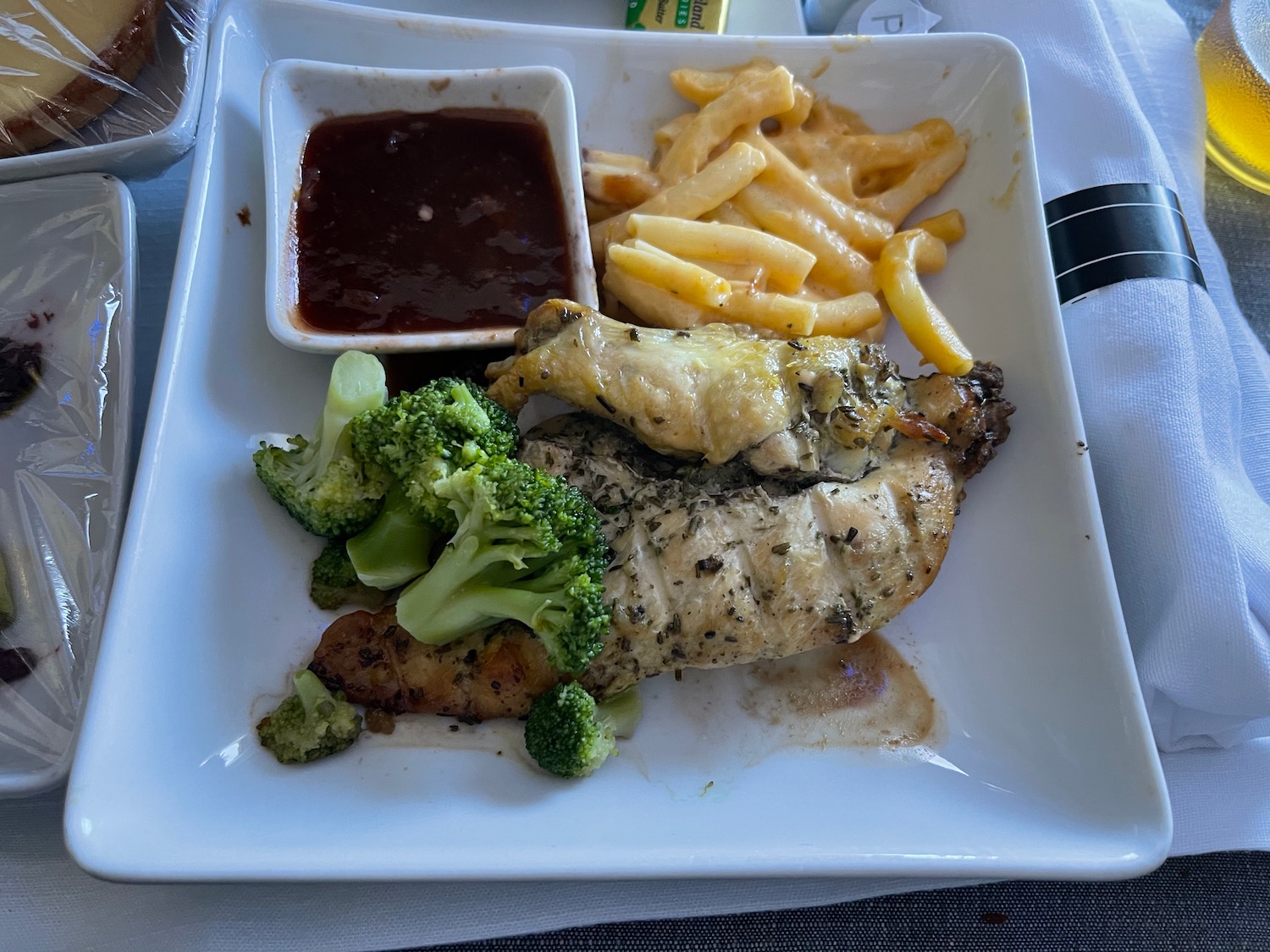 a plate of food with sauce and fries