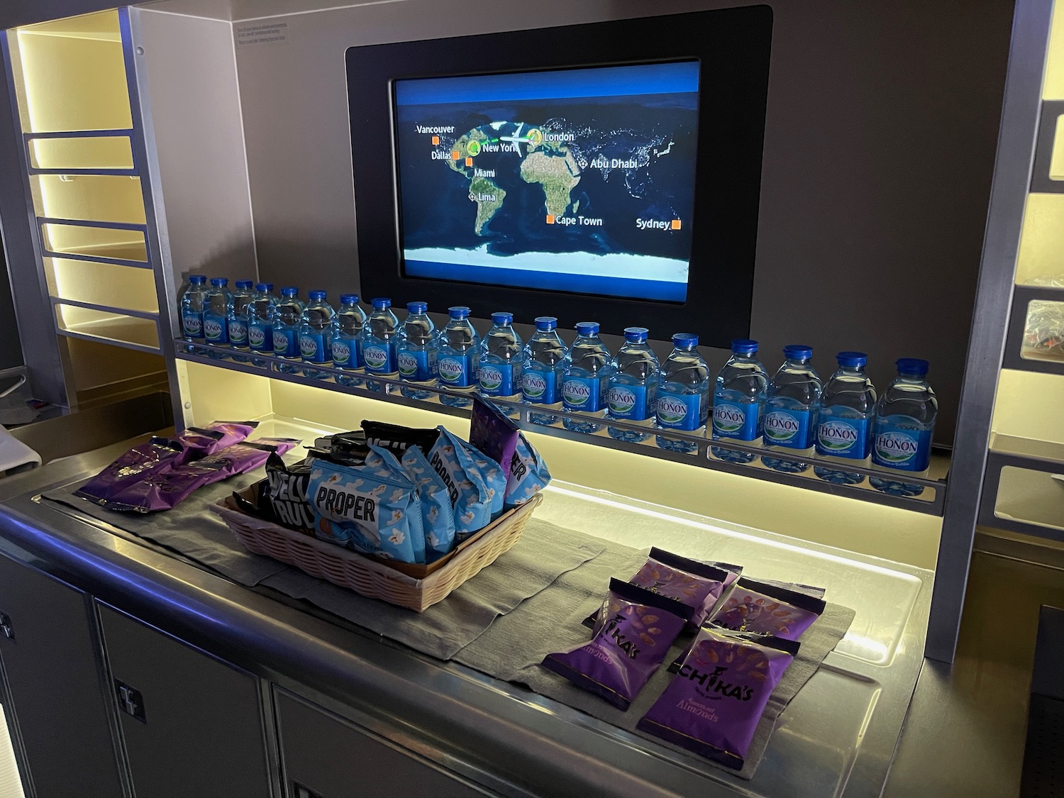 a row of water bottles and snacks on a table