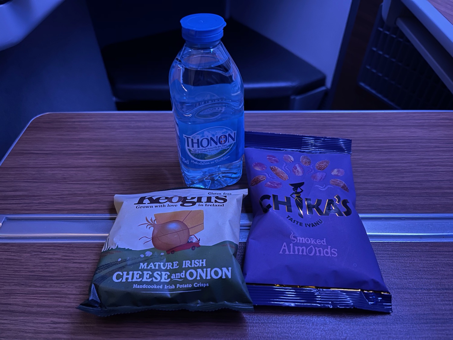 a bottle of water next to a bag of snacks