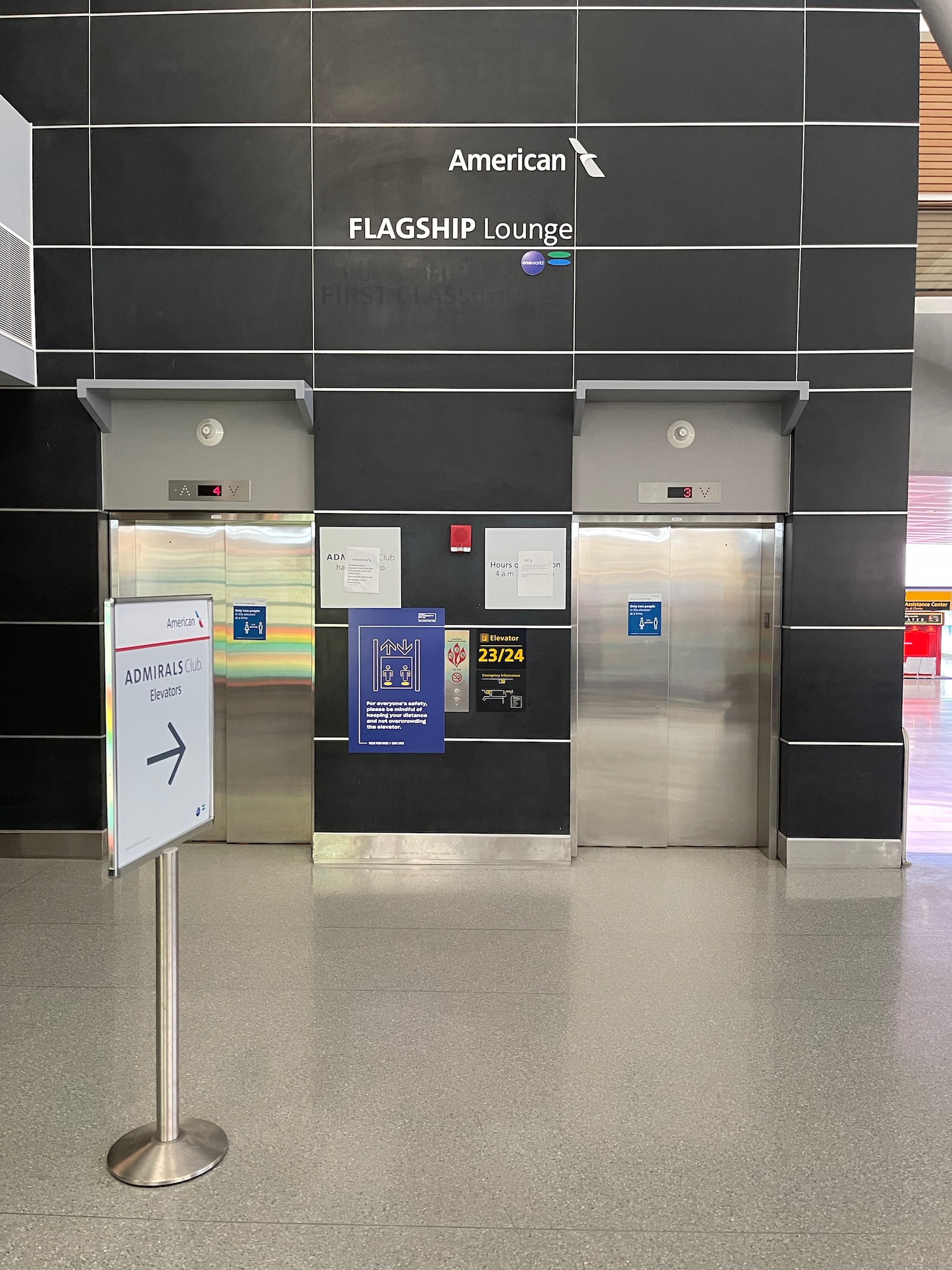 an elevator with signs and a sign on the wall