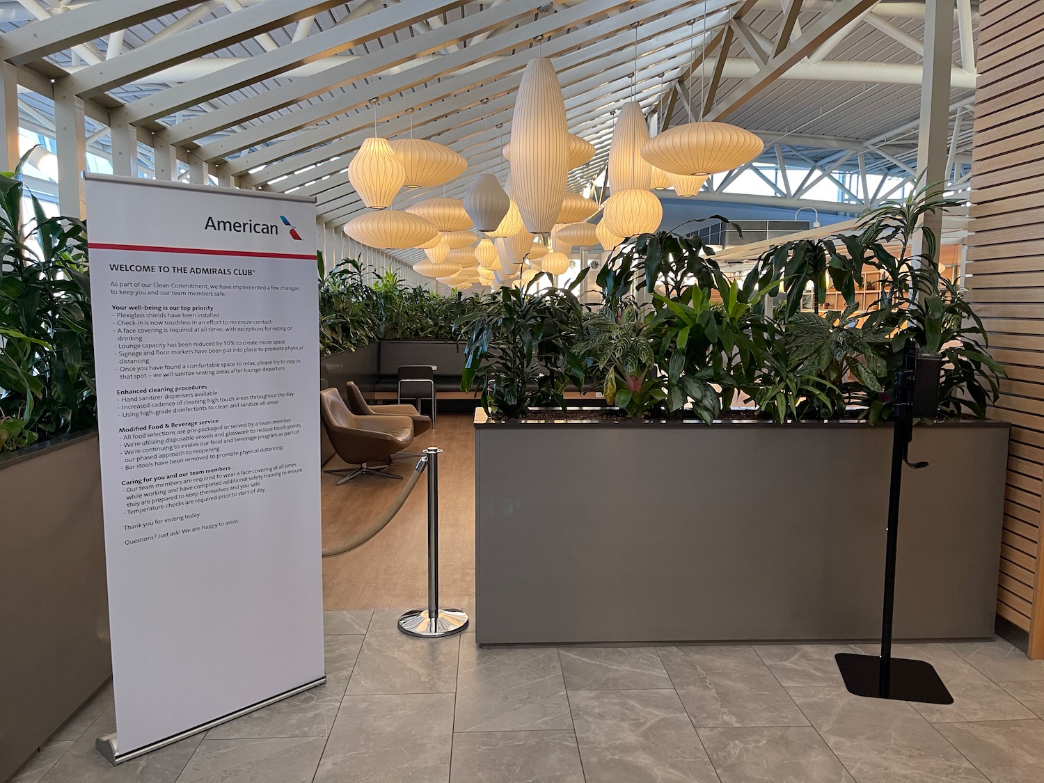 a room with a sign and plants