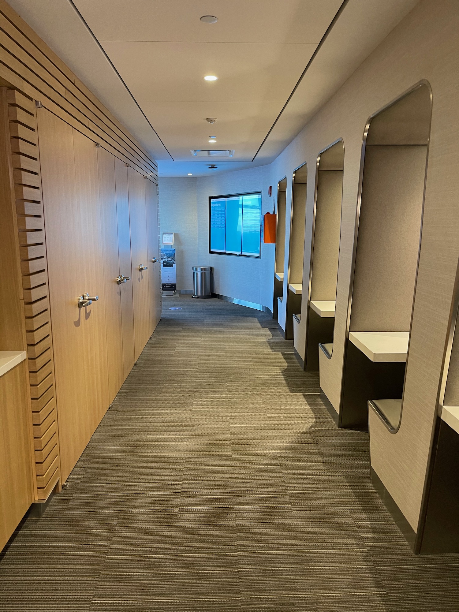 a hallway with lockers and mirrors