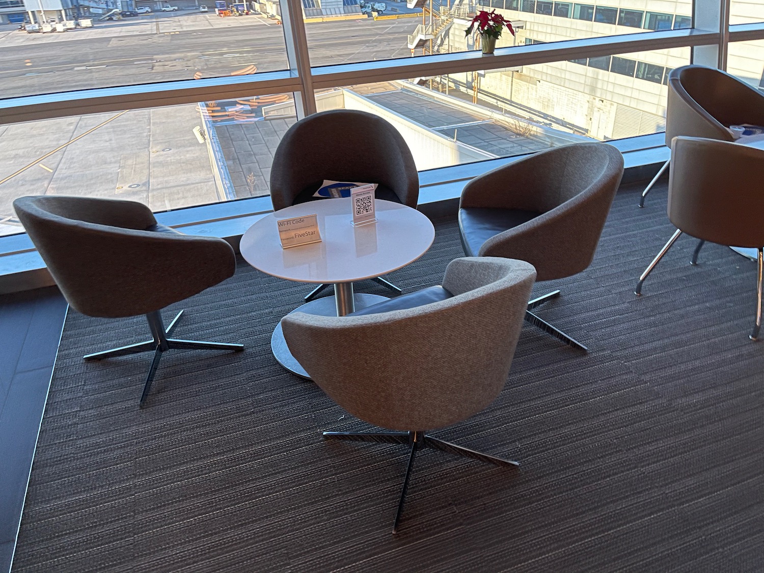 a group of chairs and a table in a room with a window