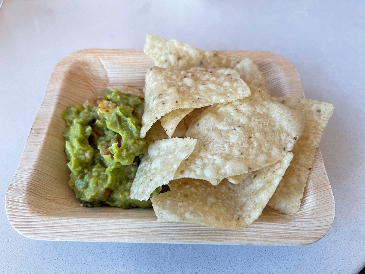 a bowl of chips and guacamole