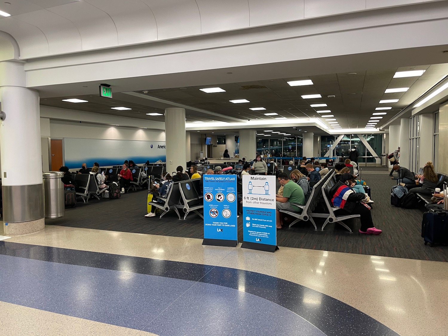 a group of people sitting in chairs in an airport