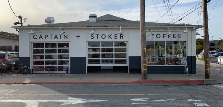 a building with windows and signs on the side of the road