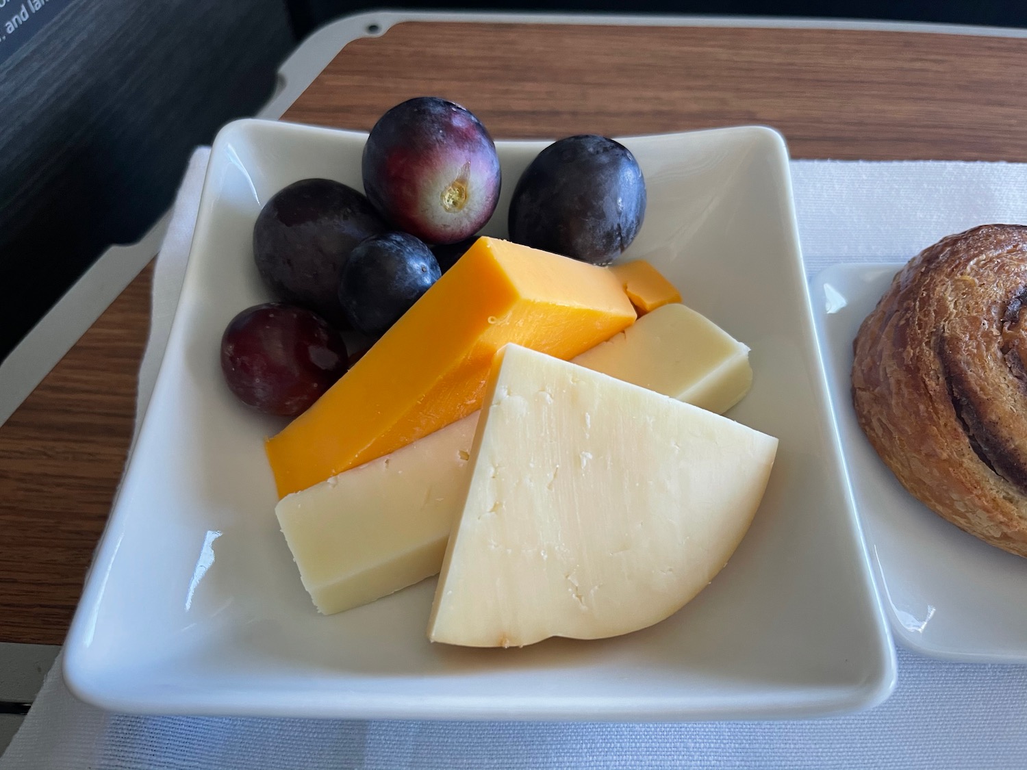 a plate of cheese and grapes