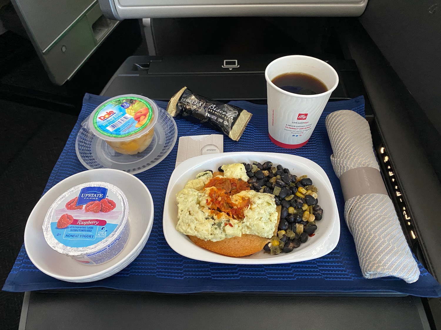 a plate of food and drinks on a blue mat