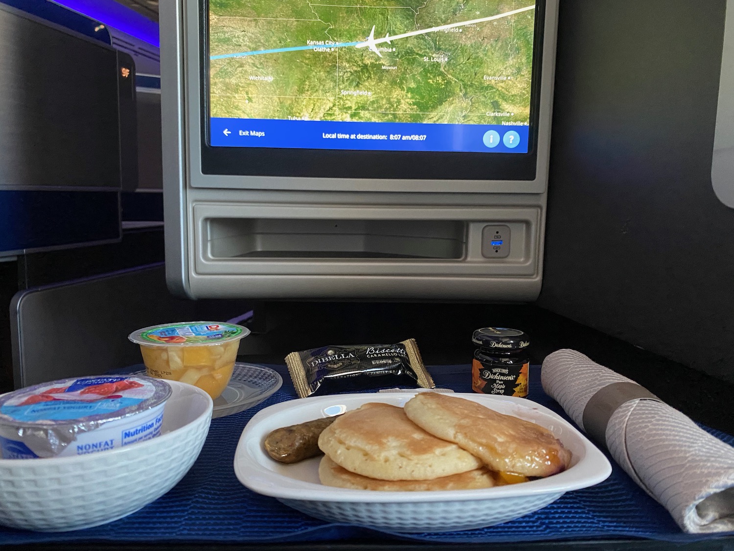 a plate of food on a table with a television