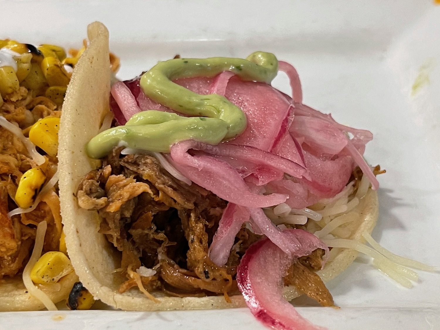 a taco with meat and onions on a plate