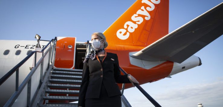 a woman wearing a face mask standing on a staircase