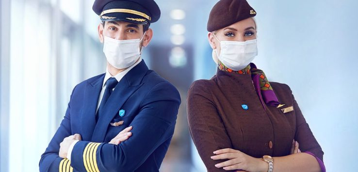 a man and woman wearing masks