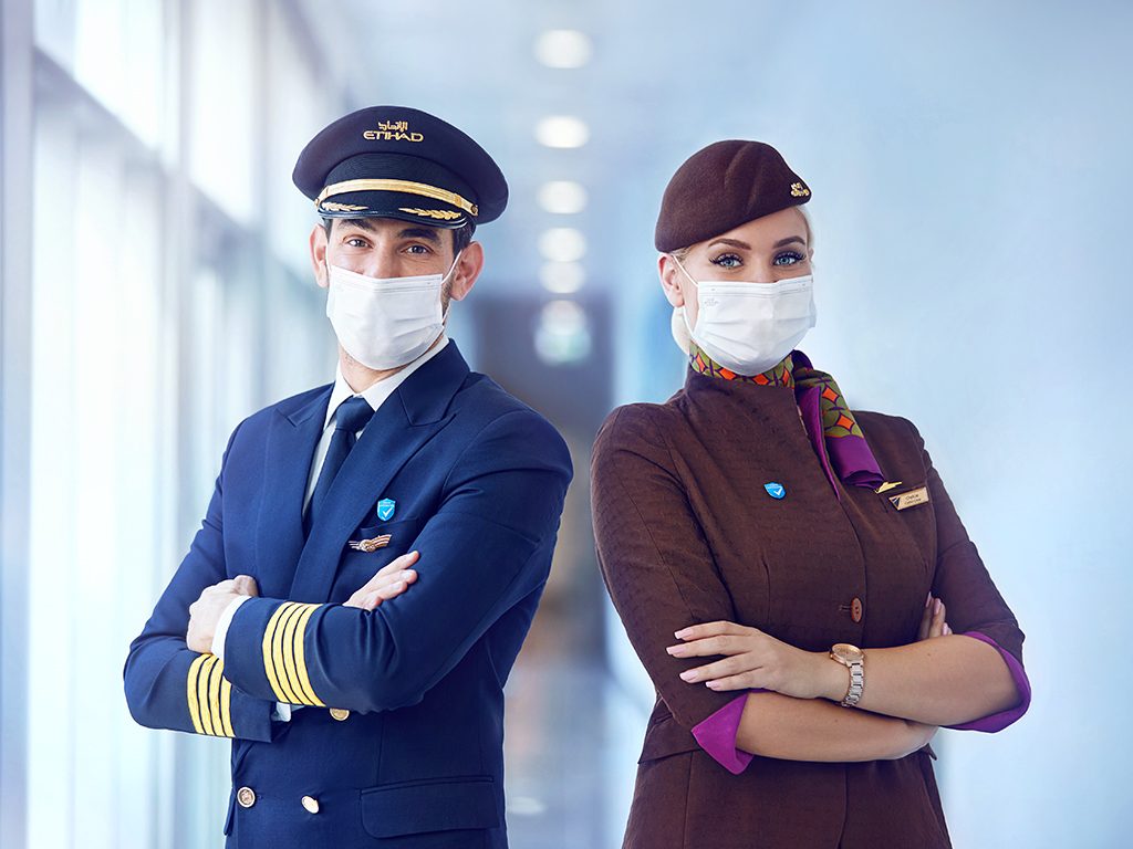 a man and woman wearing masks