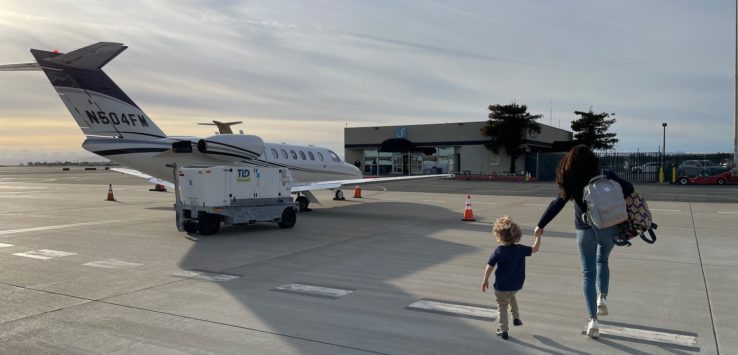 a woman and child walking on a runway