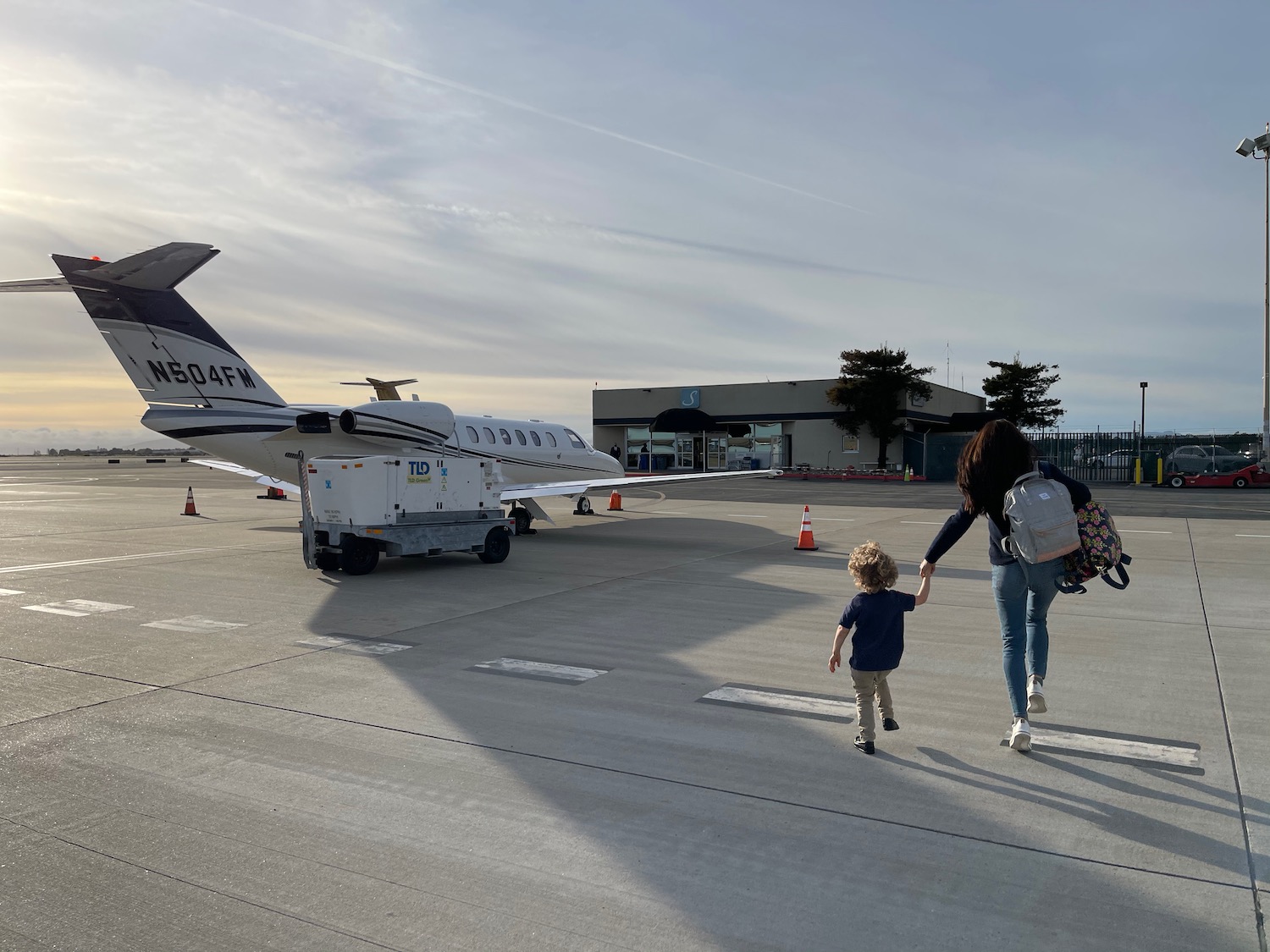 a woman and child walking on a runway