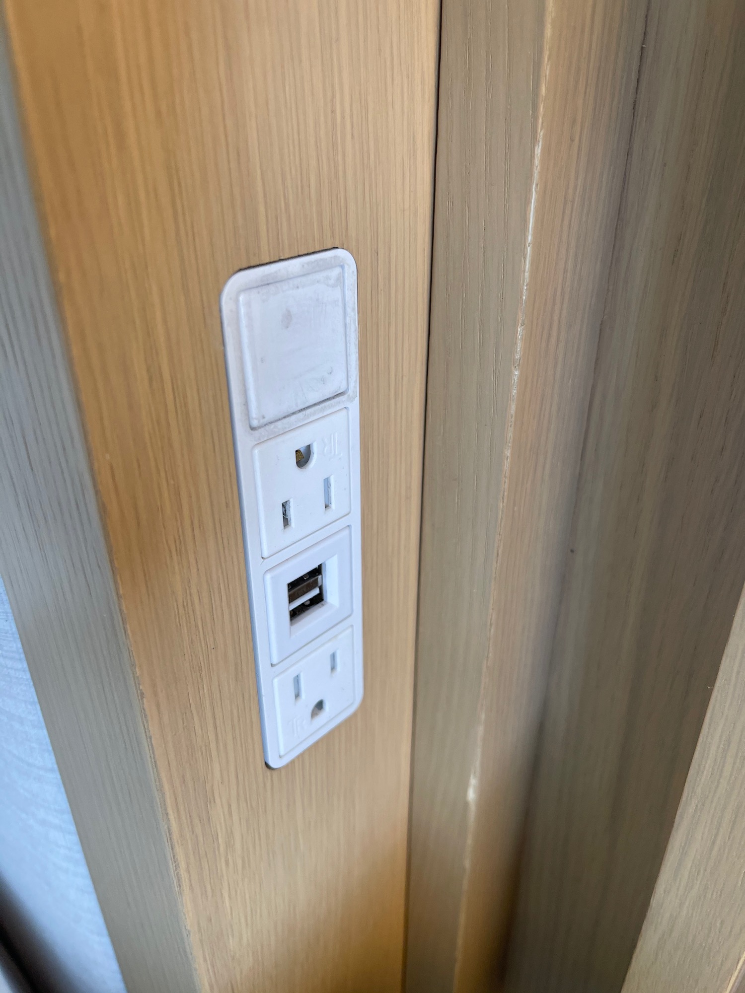 a white outlet with usb ports on a wood wall