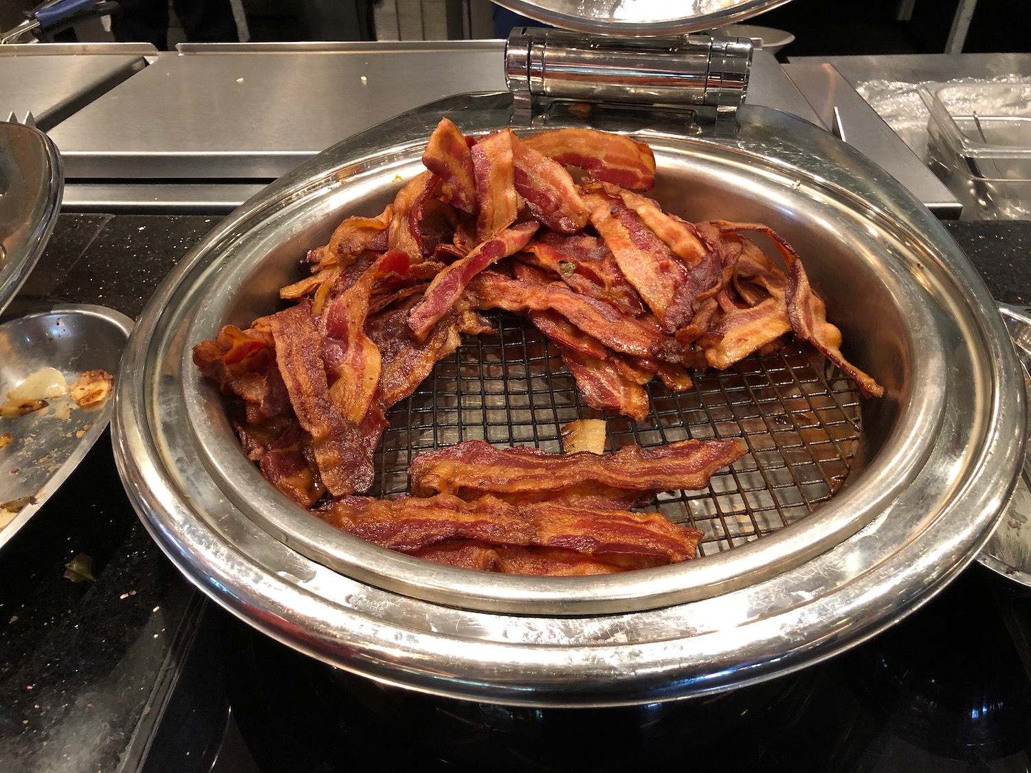 a bowl of bacon on a stove