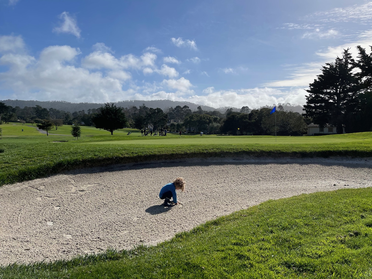 a child playing in a sand trap