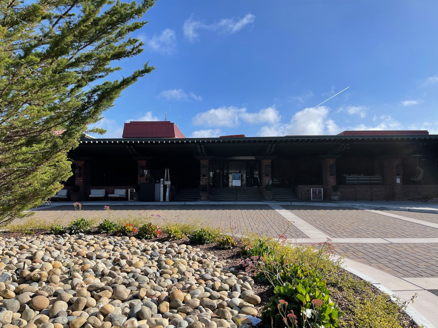 a building with a brick roof and a stone walkway