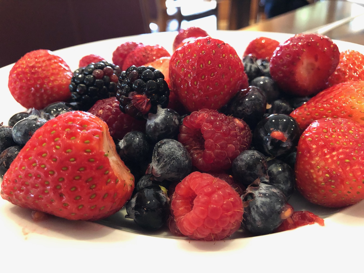 a plate of berries on a table