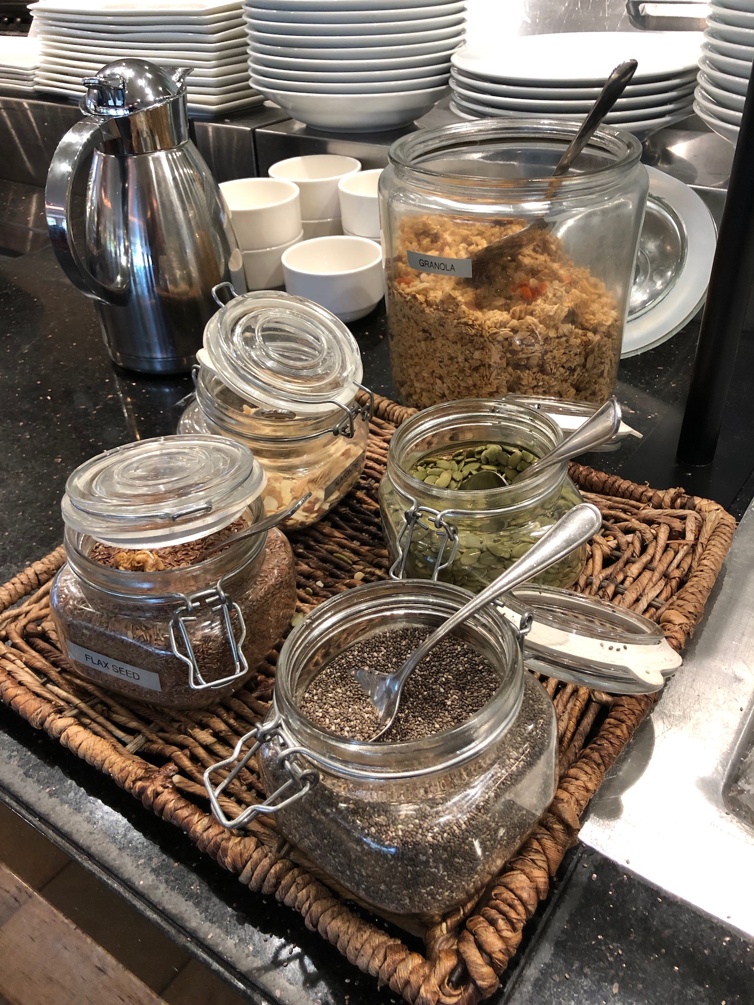 a group of glass jars with different types of food on a table
