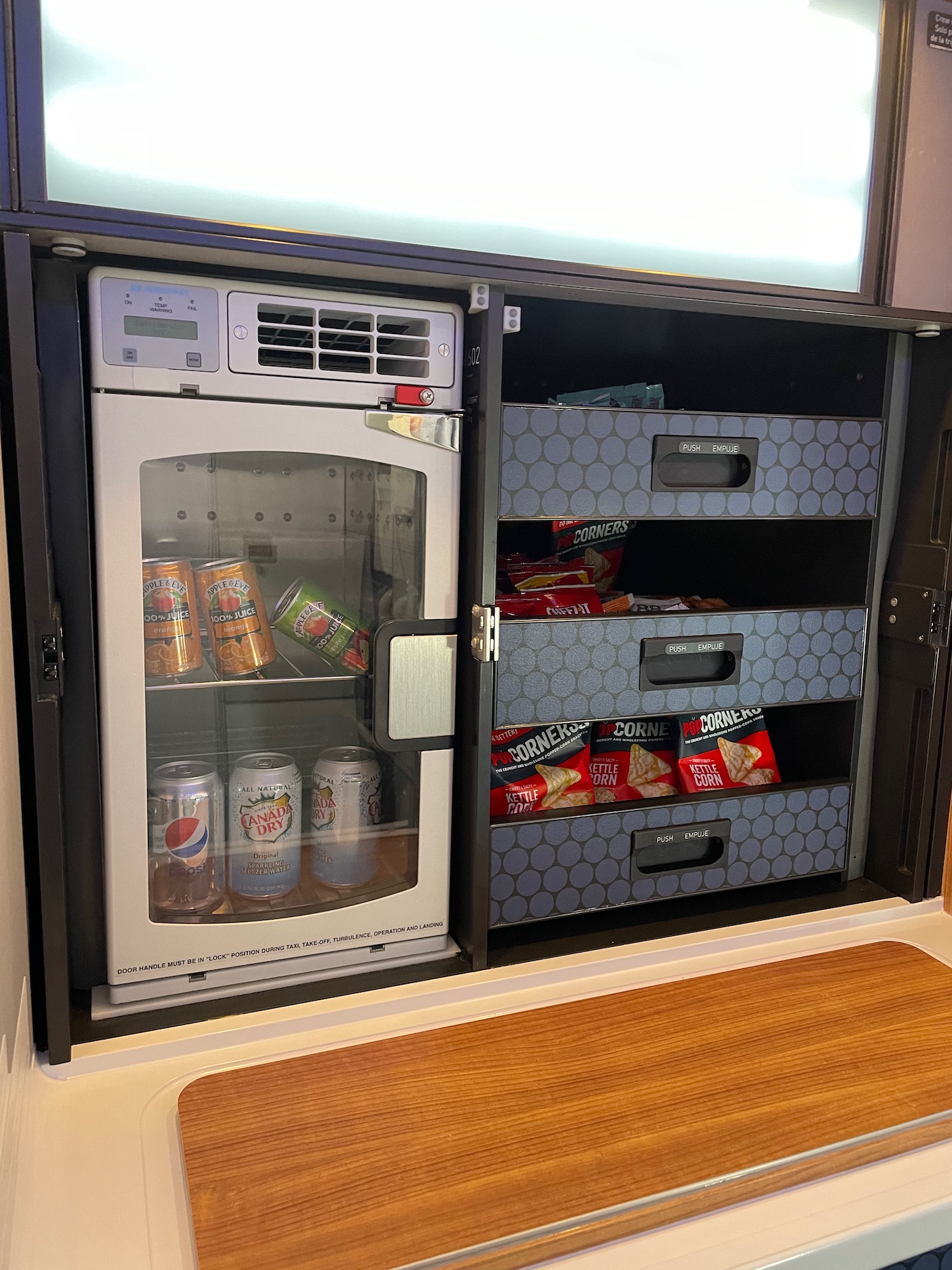 a refrigerator with drinks and snacks inside