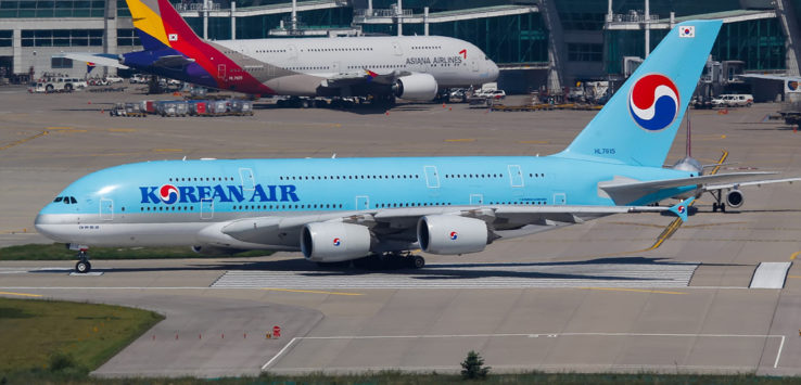 a blue airplane on a runway