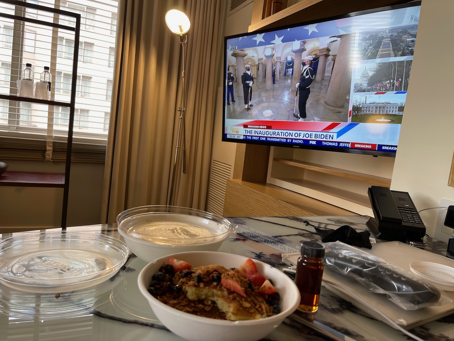 a bowl of food on a table with a television