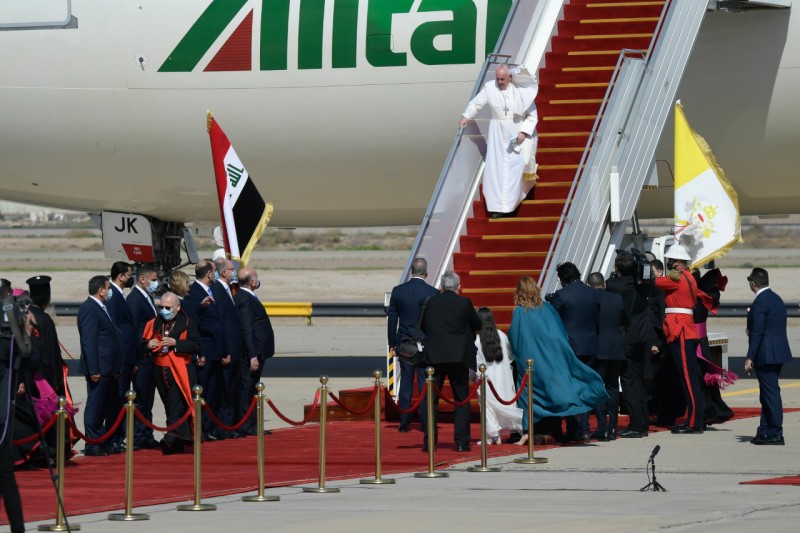 a group of people walking down a plane