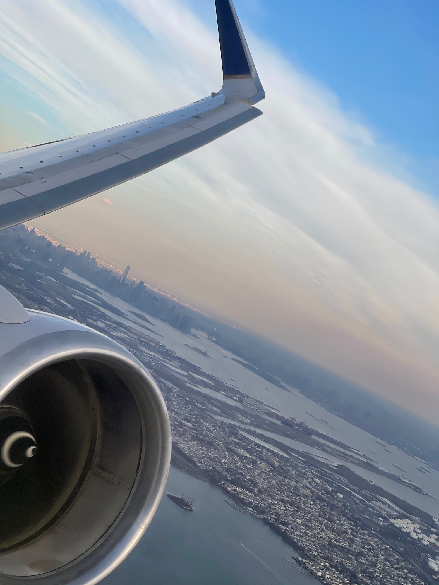 an airplane wing and a city in the distance