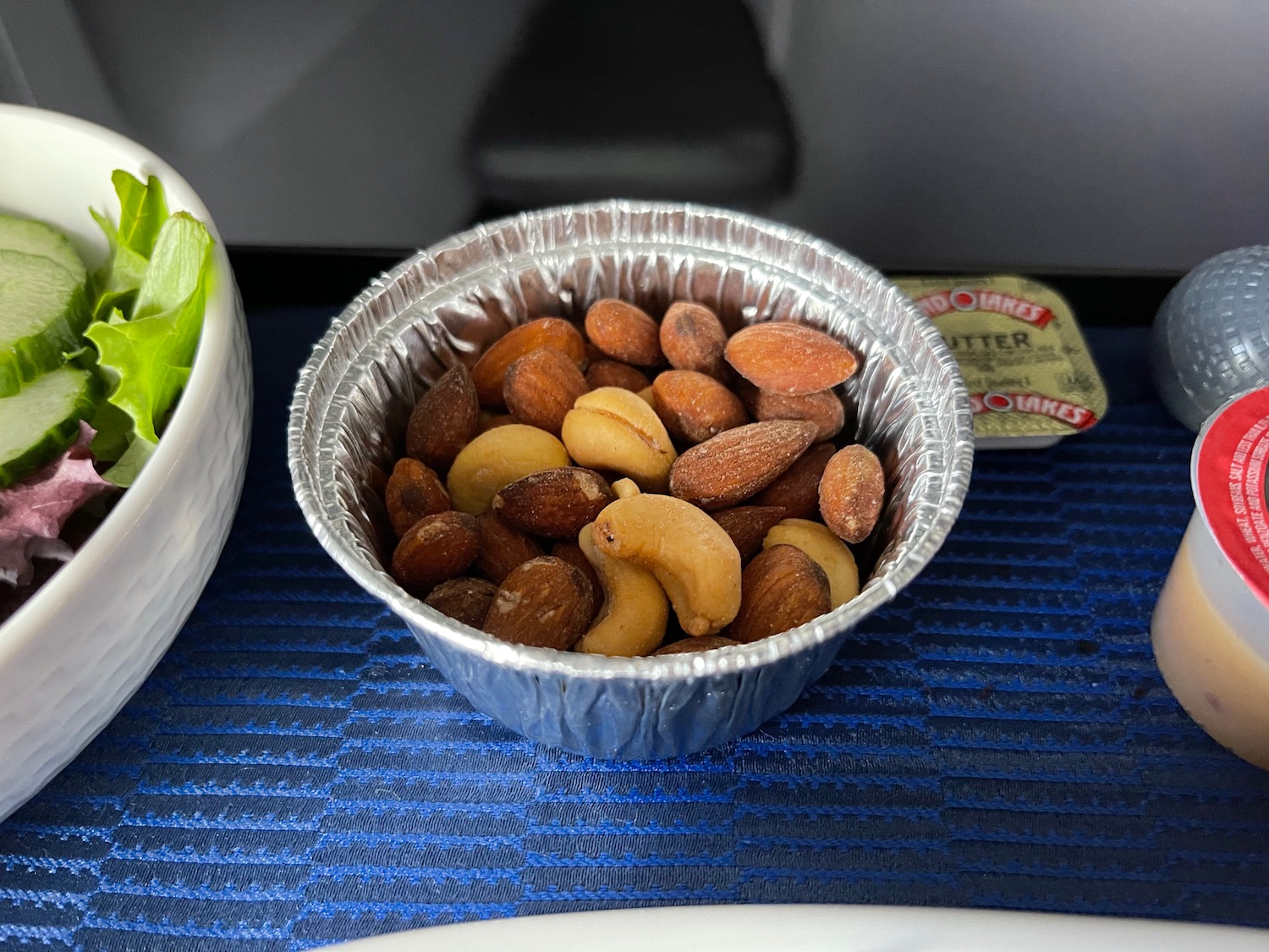 a bowl of nuts and a bowl of green onions