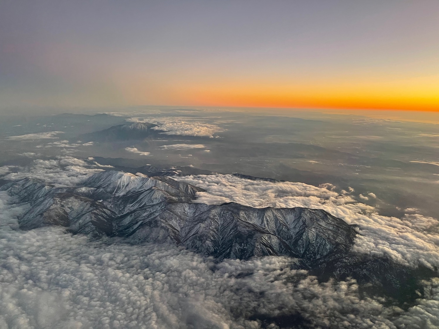 a aerial view of mountains and clouds