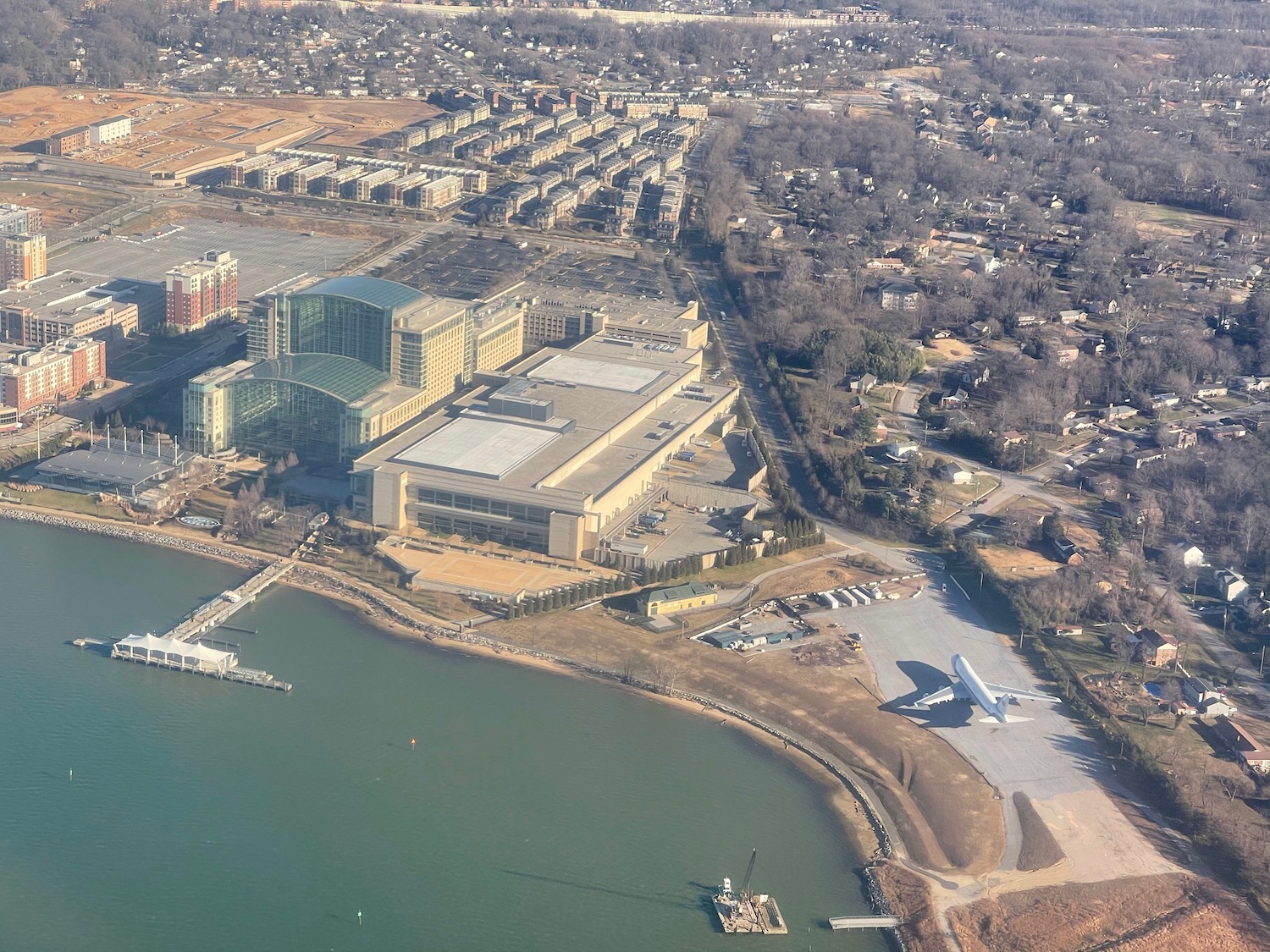 an aerial view of a building and a body of water