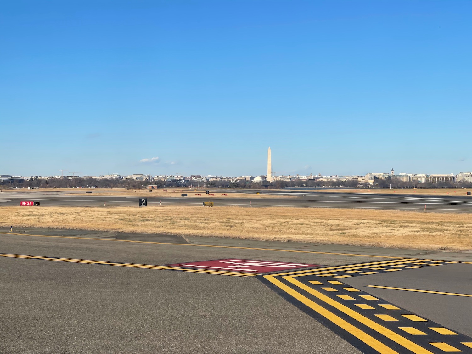 a runway with a monument in the background